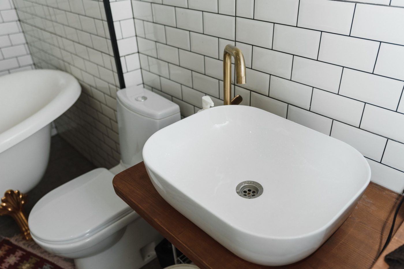 Small bathroom with a close coupled toilet, basin and white metro tiles
